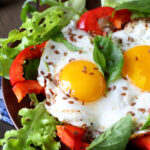 fried eggs with vegetables for breakfast, food closeup